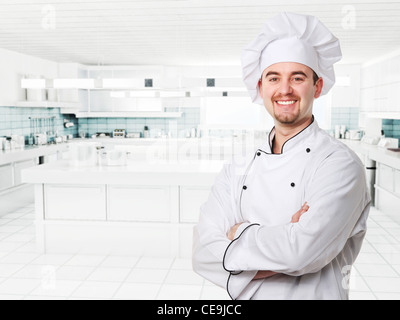 smiling young chef in modern kitchen Stock Photo
