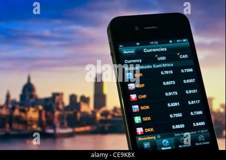 2012 iPhone screen displaying European currency rates data compared to US and Canadian dollar Stock Photo