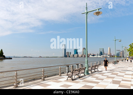 A view of the Jersey City, New Jersey skyline from across the Hudson River and the New York City Pier 25. Stock Photo