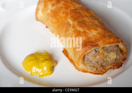 Hot sausage roll with Colman's English mustard Stock Photo