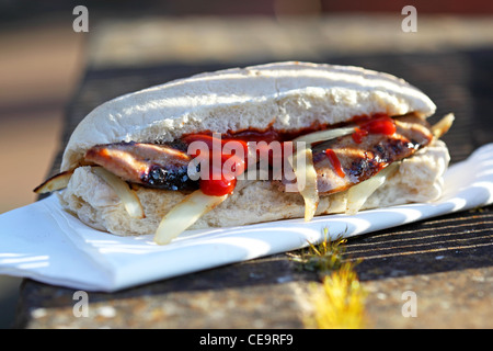 sandwich sausage barm eating on the street Stock Photo