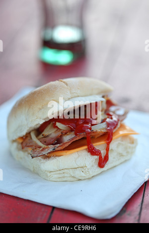 sandwich bacon barm eating on the street Stock Photo