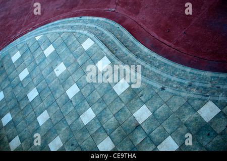 Vintage looking pavement curve. Red carpet style in tiles and concrete. Stock Photo