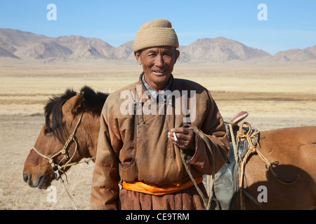 Nomad with his faithful horse in the steppes of Mongolia Stock Photo ...