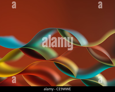 background macro image of colorful origami pattern made of curved sheets of paper, with mirror reflexion, on orange background Stock Photo