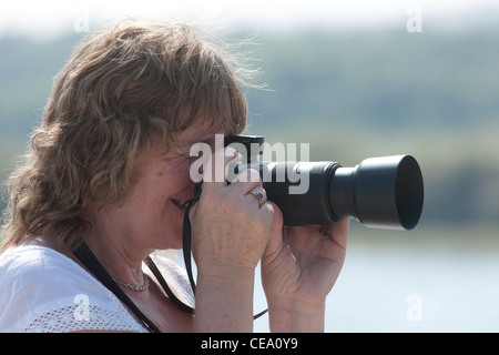 Female photographer taking photograph. Stock Photo