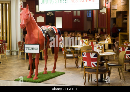 Model red horse and red telephone box in Heathrow Airport London England Stock Photo