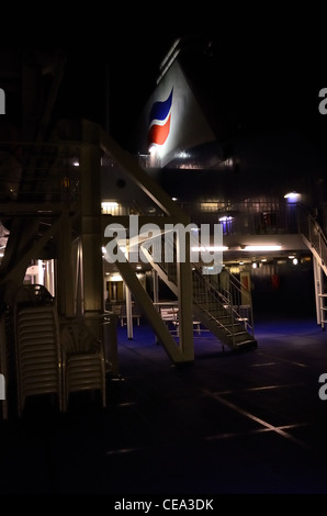 Rear deck of the MV Amorique showing the funnel and Brittany Ferries logo at night Stock Photo