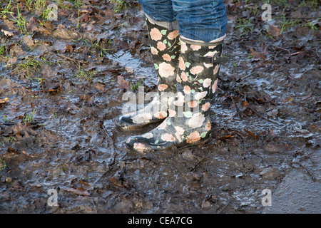 flowery wellington boot stuck in mud Stock Photo