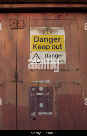 Asbestos warning sign on derelict factory Stock Photo