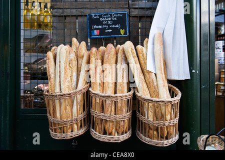 Borough Market London French food shop store fresh organic baguette bread in traditional baskets Stock Photo