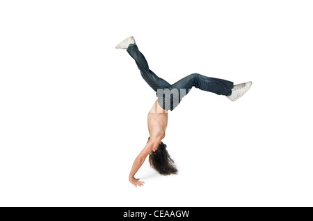 Young man performing a handstand on white background Stock Photo