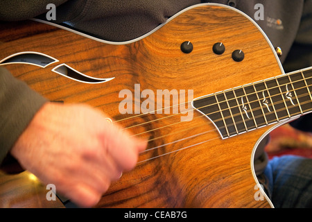 Strumming an acoustic guitar, UK Stock Photo