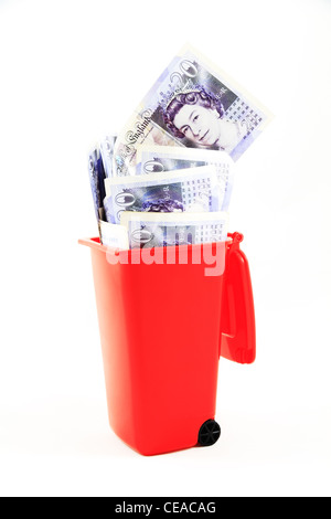 UK British English twenty pound notes note money currency sterling cash stg £s £20 cut out in a the rubbish wheelie trash bin Stock Photo