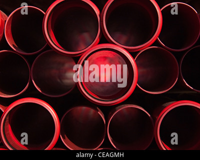 These industrial red plastic pipes are used for underground communication cables. Stock Photo