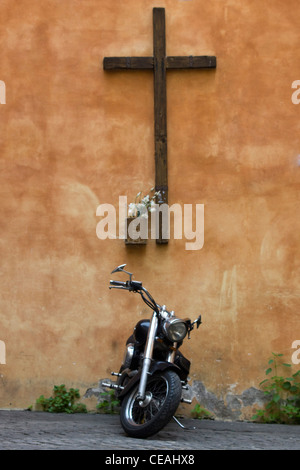 Wooden Christian cross on a wall in Rome Italy Stock Photo