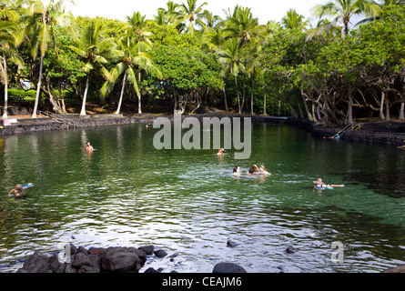 Bathers enjoy a soothing soak at this hot pond at Kapoho Point on Big Island's volcanic eastern coastline, Hawaii Stock Photo
