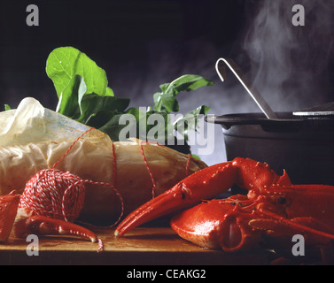 Still: Lobster, rabbit back in grease - proof - paper, cooking pot Stock Photo