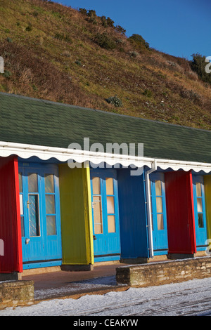 Colourful beach huts between Bournemouth and Poole promenade in December Stock Photo