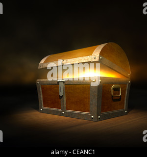 Old wooden treasure chest with strong glow from inside Stock Photo