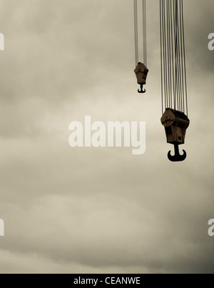 Crane hooks and heavy clouds Stock Photo