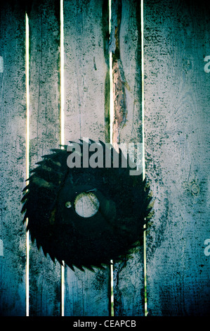 Rusty Rotary Blade hanging on wall Stock Photo