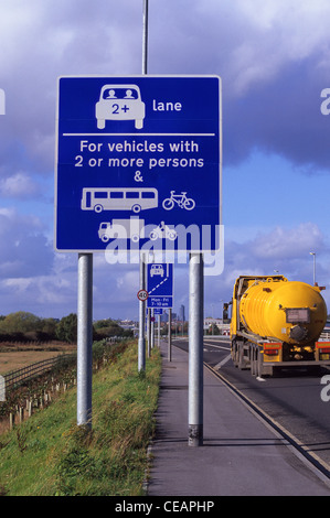 lorry passing warning roadsign of high occupancy lane ahead for vehicles carrying two or more people to ease congestion Leeds UK Stock Photo