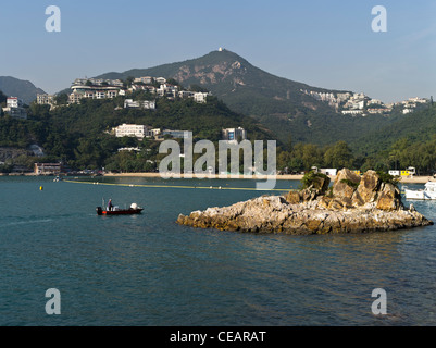 dh  DEEP WATER BAY HONG KONG Chinese boat island and beach apartment flats overlooking bay Stock Photo