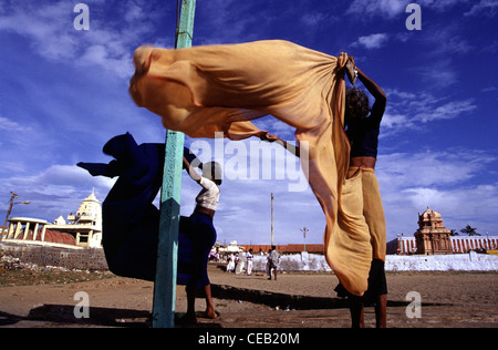 Women drying traditional Sari garment in the wind after bathing at the sea in Kanyakumari town or Cape Comorin in Tamil Nadu South India Stock Photo