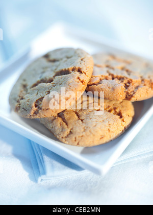 Ginger snap cookies (biscuits) served on white table-ware. Stock Photo