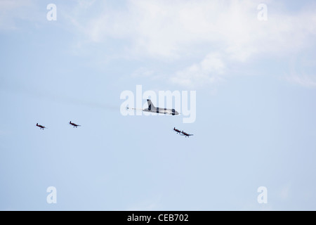 The Blades perform a flypast with the visiting Avro Vulcan B2, Sywell, Northamptonshire, UK Stock Photo