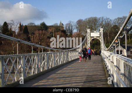 Chester Cheshire View along Queens Park Suspension Bridge over River Dee with pedestrians crossing Stock Photo