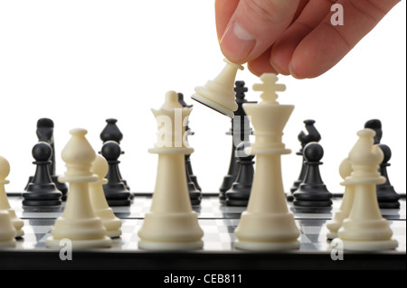 Pawn in hands over a chessboard. Selective focus Stock Photo