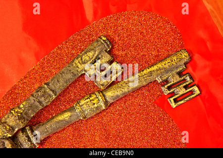 Ornate brass keys, red heart Stock Photo