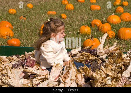Child in corn husks at the Half Moon Bay Art and Pumpkin Festival Stock Photo