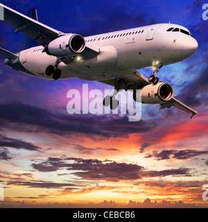 Jet aircraft is maneuvering in a sky at sunset. Square composition. Stock Photo