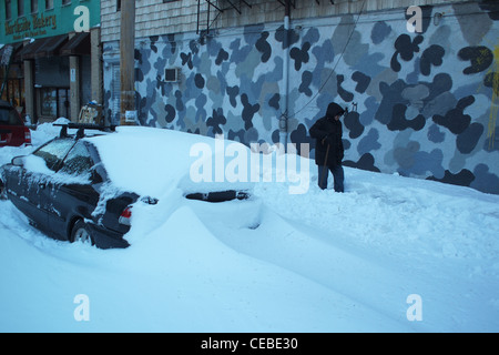 Man walking on street after Christmas blizzard of 2010, Brooklyn, New York Stock Photo