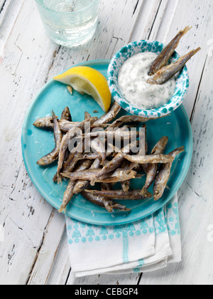 A single serving of deep fried whitebait with tartare sauce dip Stock Photo