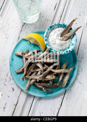 A single serving of deep fried whitebait with tartare sauce dip Stock Photo