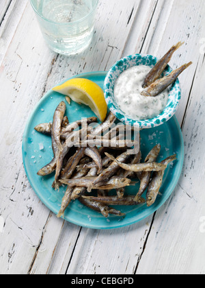 A single serving of deep fried whitebait with tartare sauce dip Stock Photo