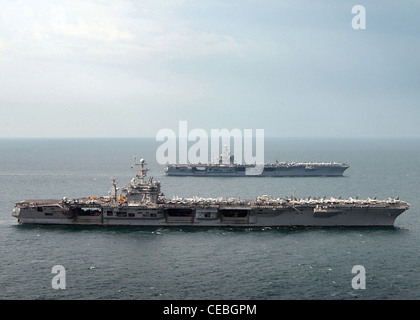 The Nimitz-class aircraft carrier USS Harry S. Truman (CVN 75), foreground, is relieved by the Nimitz-class Aircraft Carrier USS Carl Vinson (CVN 70) in the Persian Gulf. The Harry S. Truman Carrier Strike Group completed nearly four months in the Persian Gulf in support of the Global War on Terrorism Stock Photo