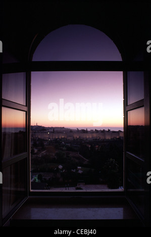 Sunrise over the old city seen through arched window of King David hotel West Jerusalem  Israel Stock Photo