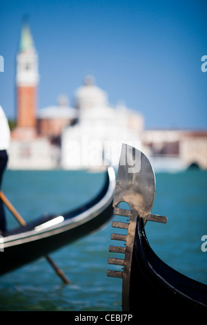 Detail of a gondola 'ferro di prua' or prow iron, in front of San Giorgio Maggiore, Venice, Italy Stock Photo