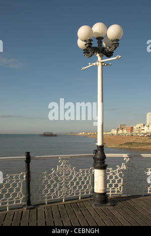 The view west from Brighton Pier with the remains of the West Pier in the background. Stock Photo