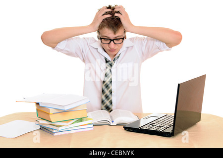 teenager student sits behind a desk isolated on white background Stock Photo