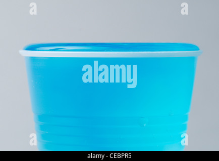Water above rim of cup - surface tension caused by cohesion between the polar water molecules. Before/after sequence with CEBPR7 Stock Photo