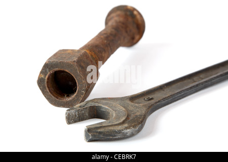 Wrench and rusty bolt with nut on a white background Stock Photo