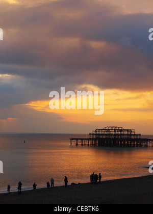 Brighton's iconic West Pier silhoutted against a fiery sunset Stock Photo