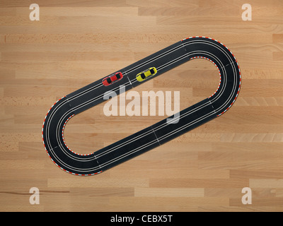 Slot cars on a race track on a wooden floor Stock Photo