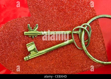 Two 'classic' brass keys, red heart Stock Photo